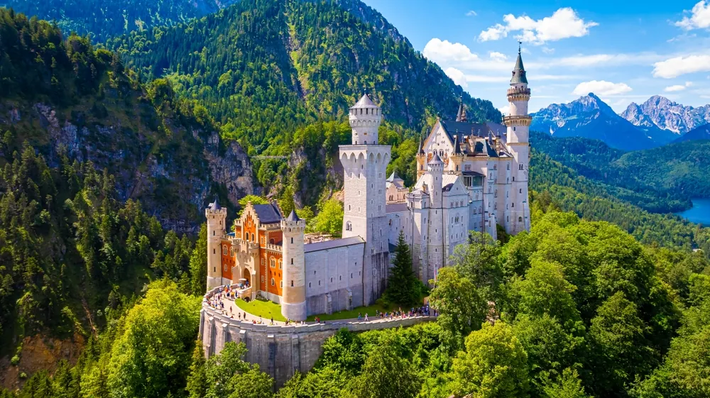 A view of Neuschwanstein Castle, a 19th-century fairy-tale-like palace perched on a rugged hill above the village of Hohenschwangau in southwest Bavaria, Germany, Europe