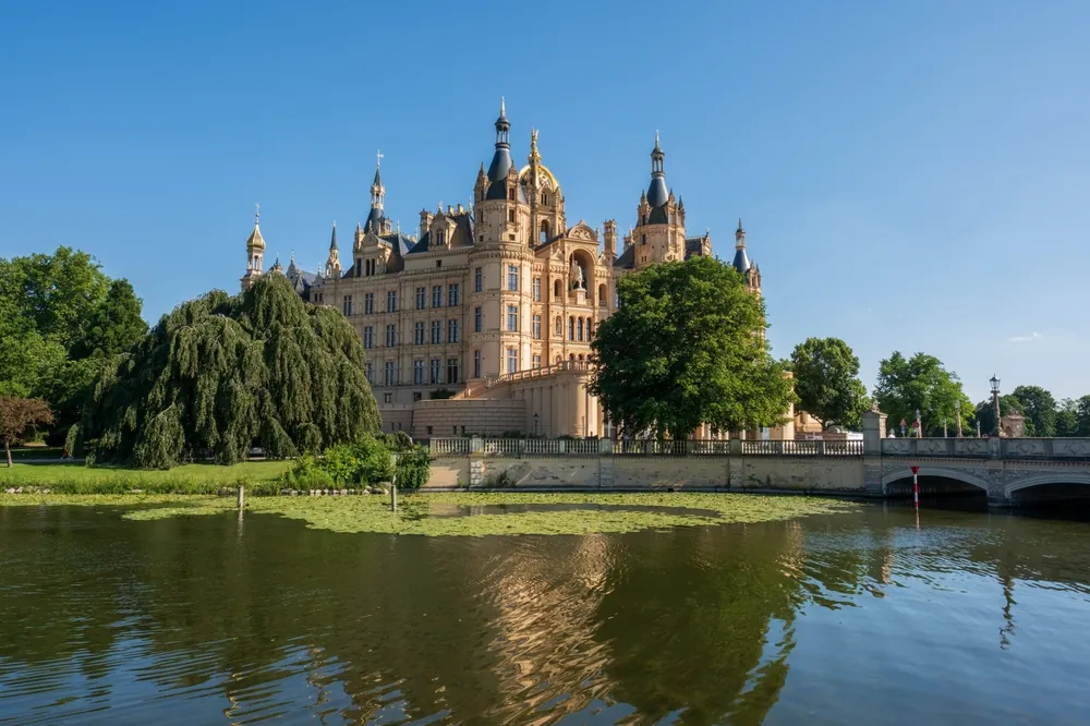 Stunning Schwerin Castle in northern Germany, surrounded by beautiful trees and lake