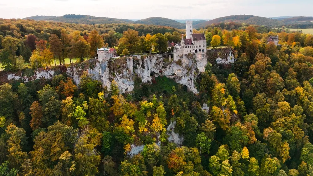 Aerial drone view medieval Lichtenstein castle on mountain, autumn Baden-Wurttemberg, German