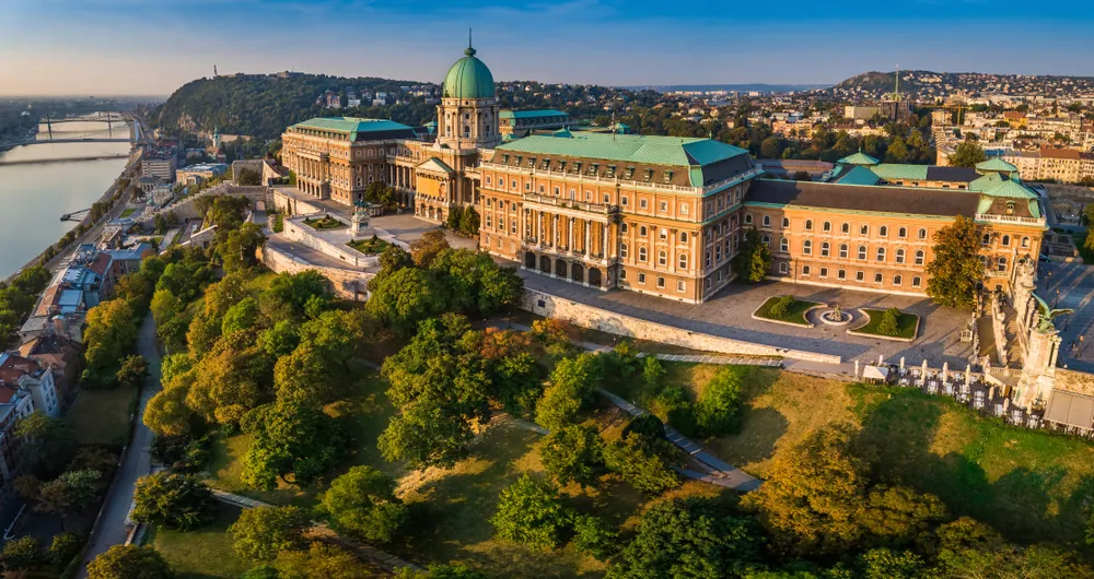 Budapest, Hungary - Aerial panoramic view of the beautiful Buda Castle Royal Palace at sunrise with Gellert Hill and Statue of Liberty at background