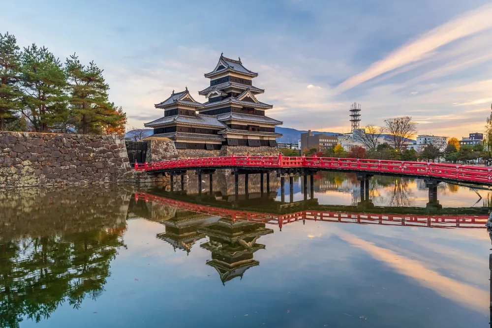 Matsumoto Nagano Japan, city skyline at Matsumoto Castle with autumn foliage season at sunset