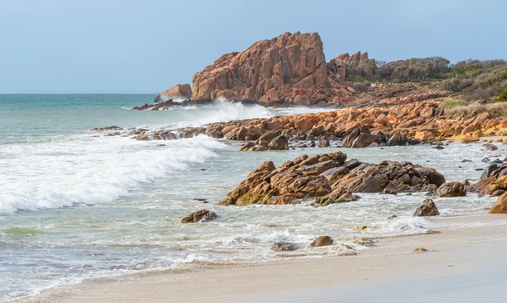 Castle Rock, near Dunsborough in Western Australia, is a massive chunk of orange granite standing tall at the end of beautiful Castle Bay.