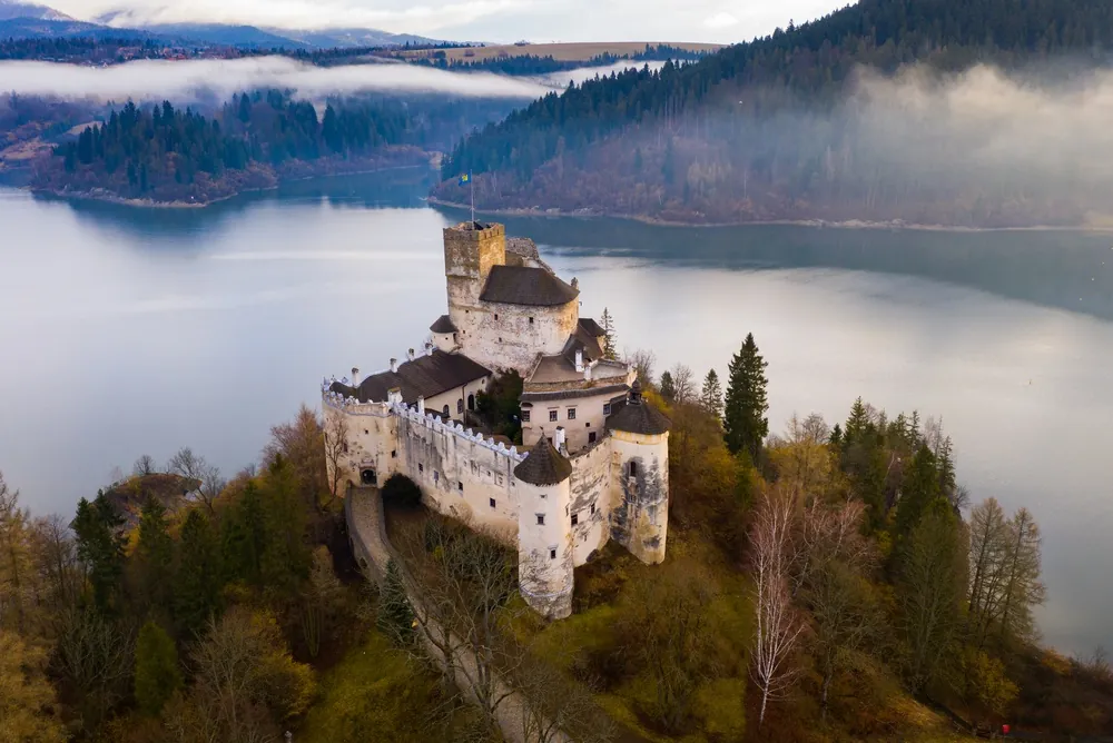 View of medieval Niedzica castle on Dunajec River at early spring morning, Poland