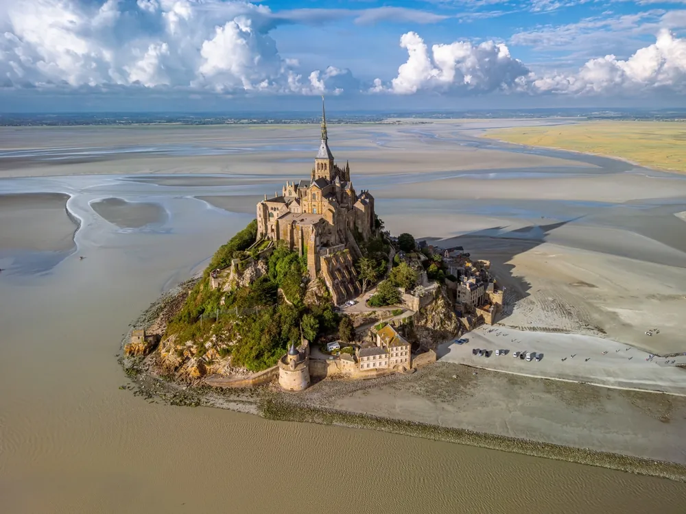 The drone aerial view of saint Michael's mount, France. saint Michael's mount is a tidal island and mainland commune in Normandy, France.