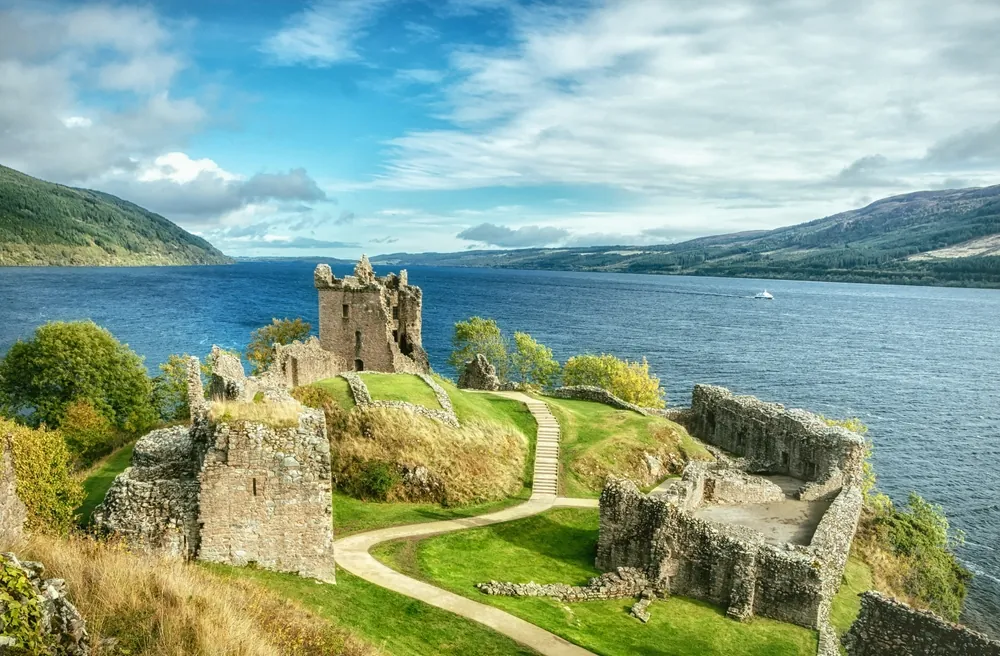 Urquhart Castle is a ruined castle on Loch Ness in the Scottish Highlands. The castle is located 21 kilometers southwest of Inverness and 2 kilometers east of the village of Drumnadrochit.