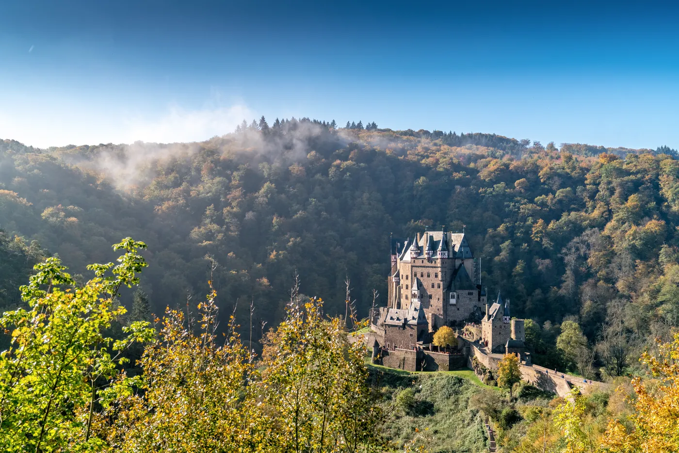 Burg Eltz rising from the forest, a medieval fairytale castle in Germany