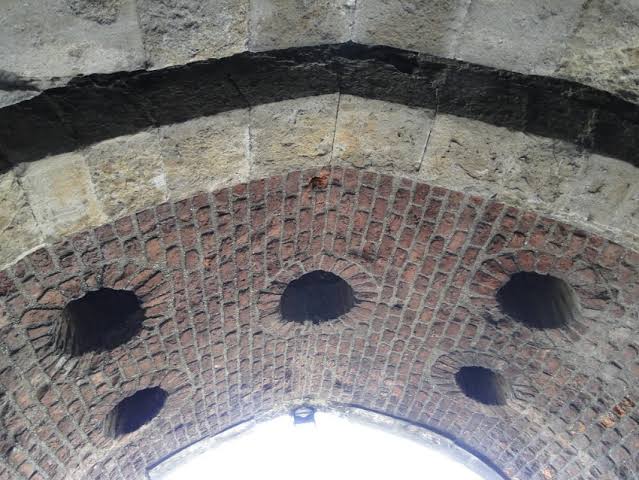 Murder-holes in a castle gateway, once said to pour boiling oil on attackers