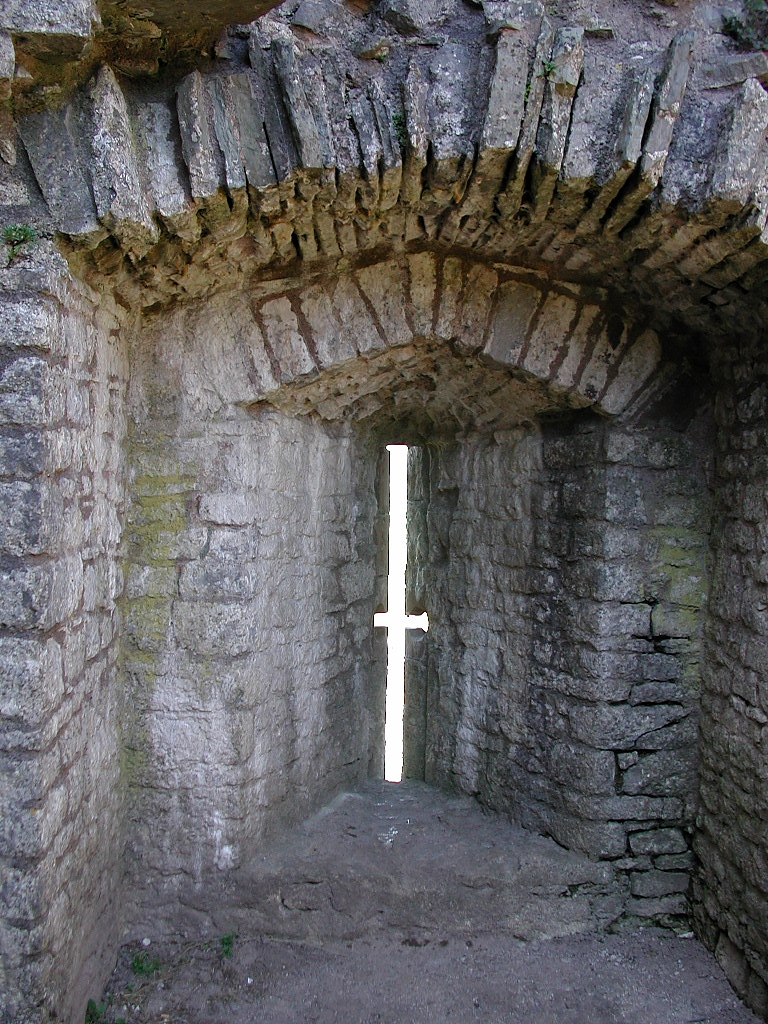 Arrow slits cut into a castle wall, sized for crossbows